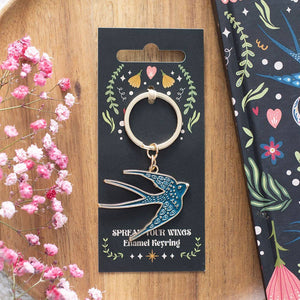 Blue enamel swallow keyring on Spread Your Wings folk art backing card