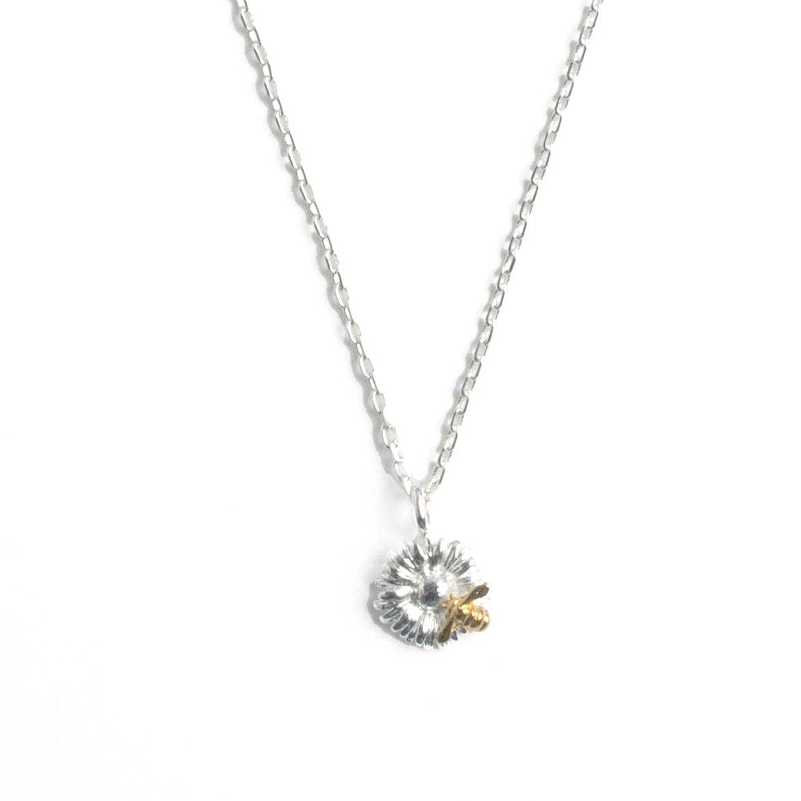 Close-up of bee and flower detail on two-tone pendant
