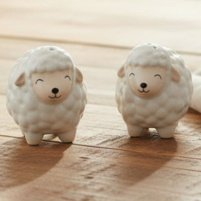 Pair of white ceramic sheep salt and pepper shakers with fluffy textured bodies and smiling faces