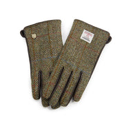 Chestnut herringbone Harris Tweed ladies gloves with leather detailing laid flat. 