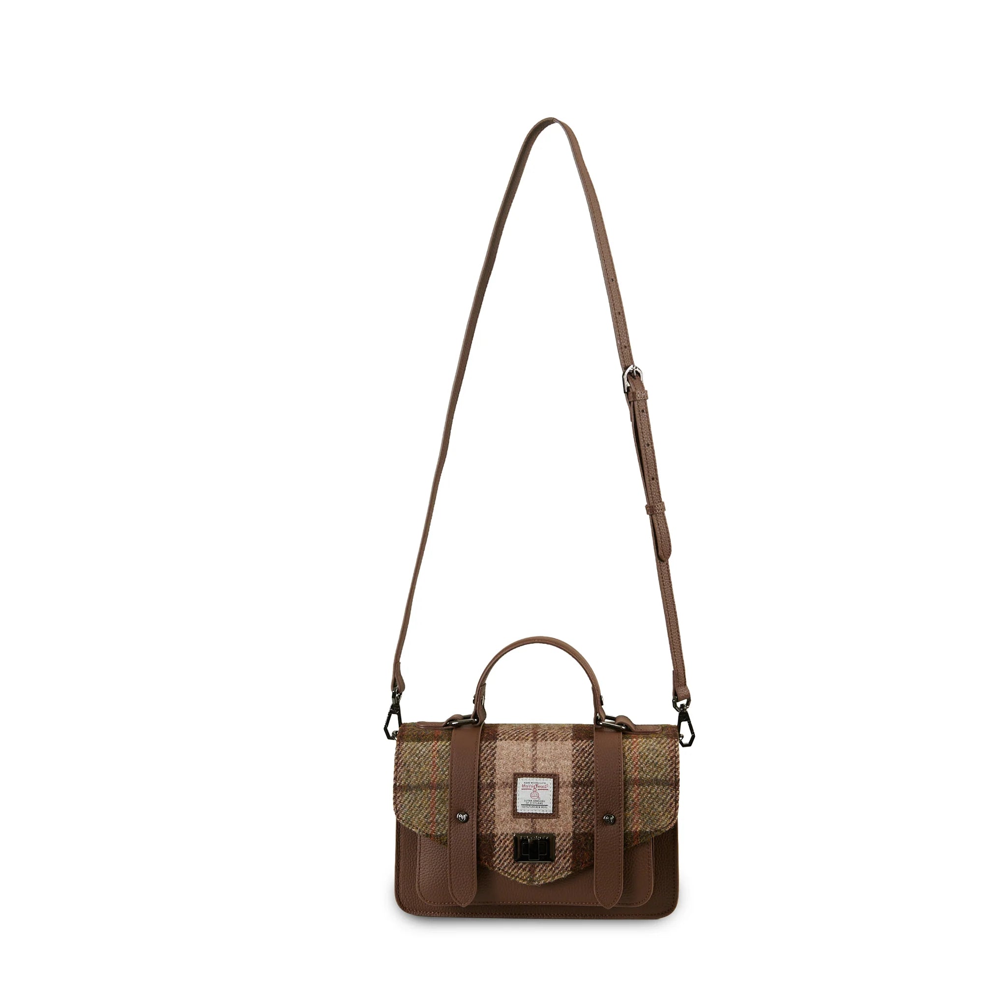Chestnut Harris Tweed medium leather satchel worn with adjustable shoulder strap.