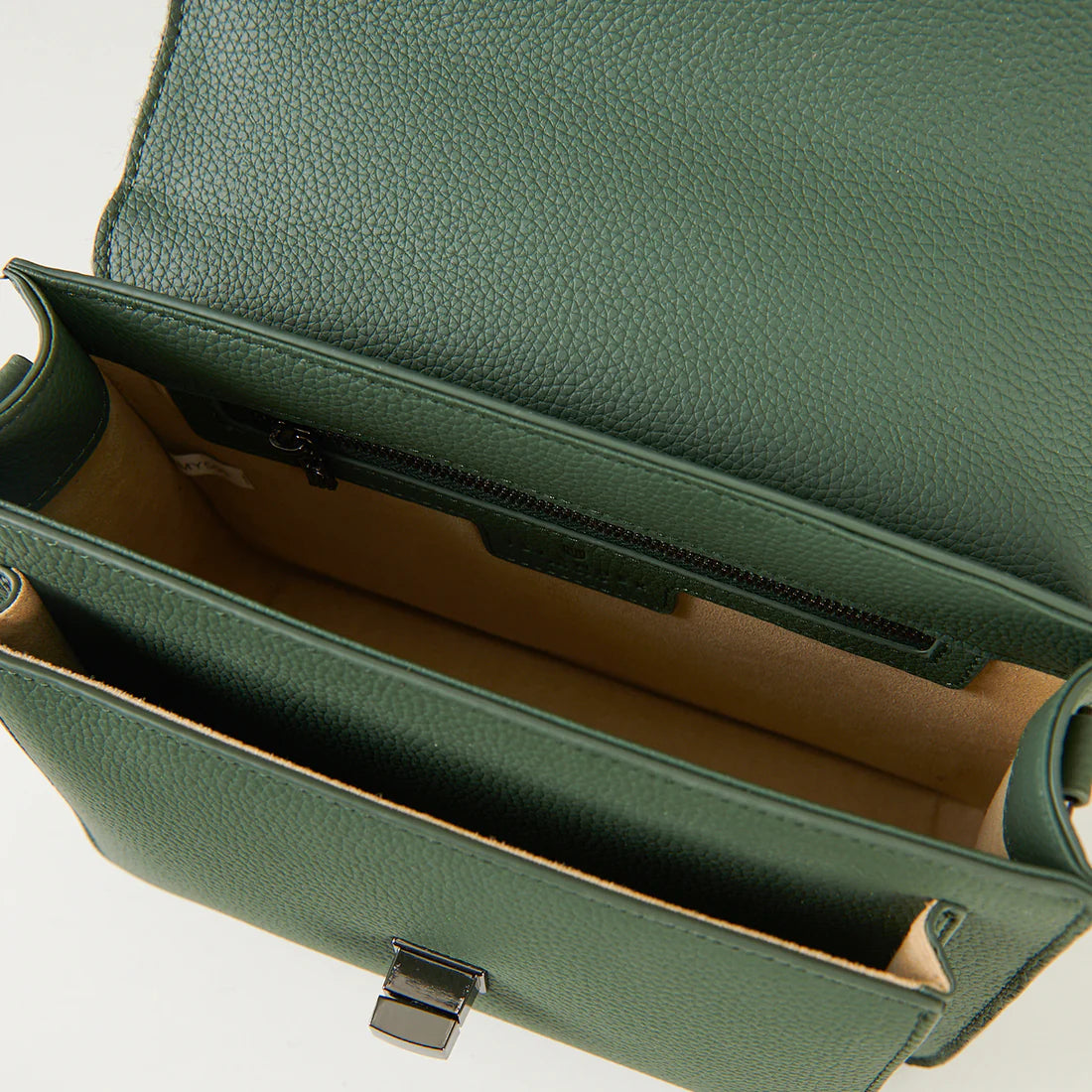 Interior detail of dark green leather satchel with zip pocket and lining.