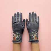 Grey embroidered rabbit gloves pair showing front design on pink background
