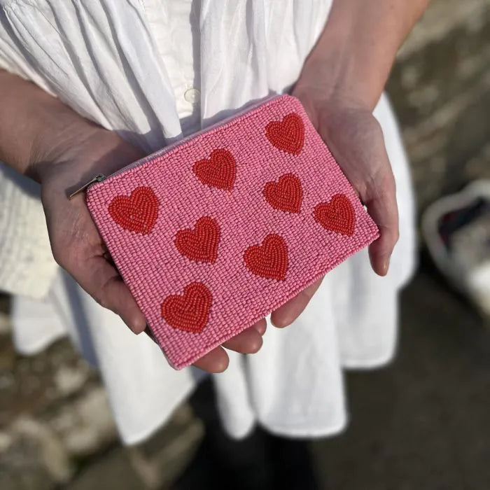 Hearts beaded purse held in hand showing heart pattern detail