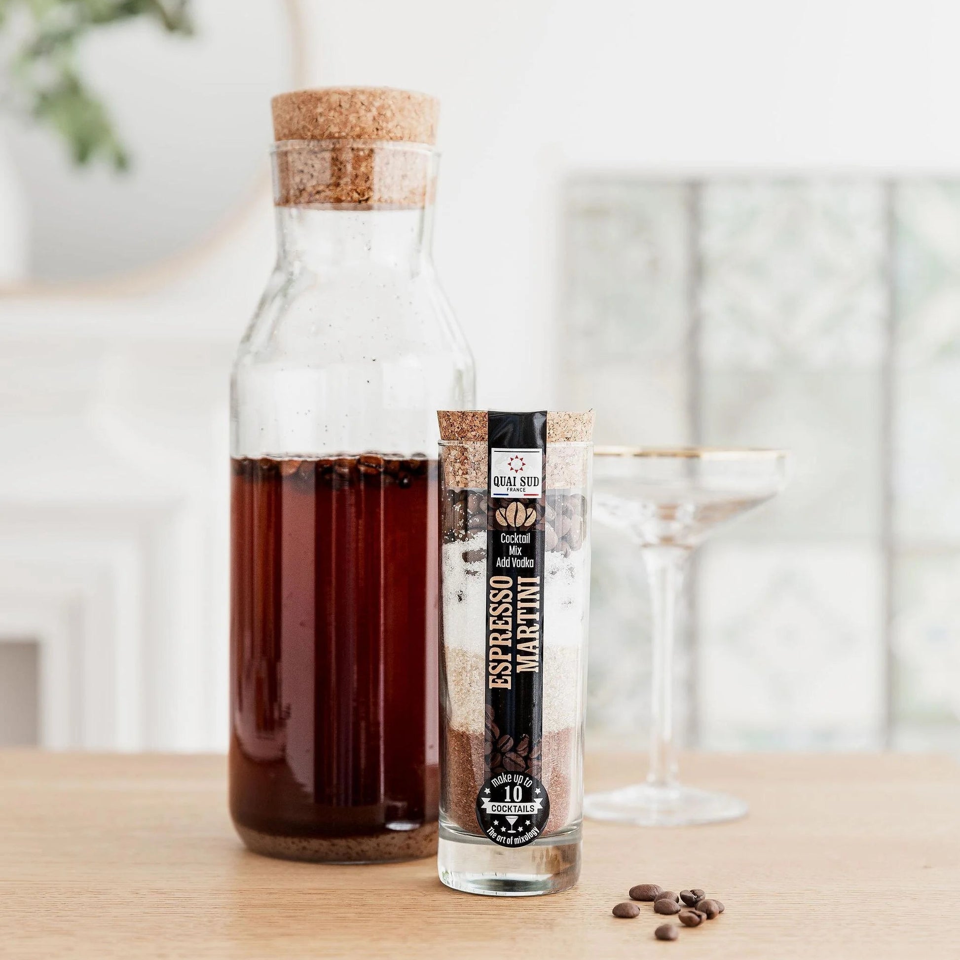 Infused Espresso Martini cocktail mix in carafe beside serving glass.