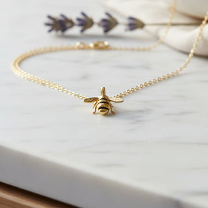 Gold-plated bee pendant with hand-painted enamel stripes on chain