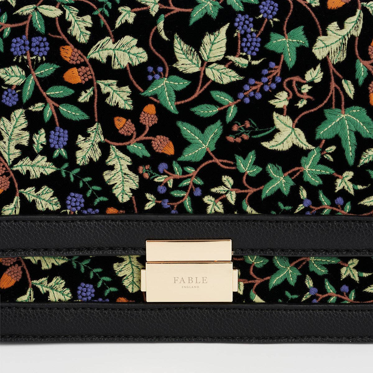 Close-up of acorn ivy embroidery detail and Fable England gold clasp