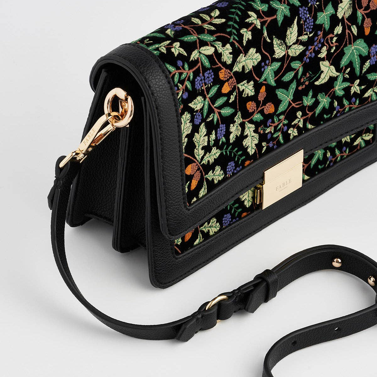 Close-up of Cathy bag gold hardware clasp and strap attachment