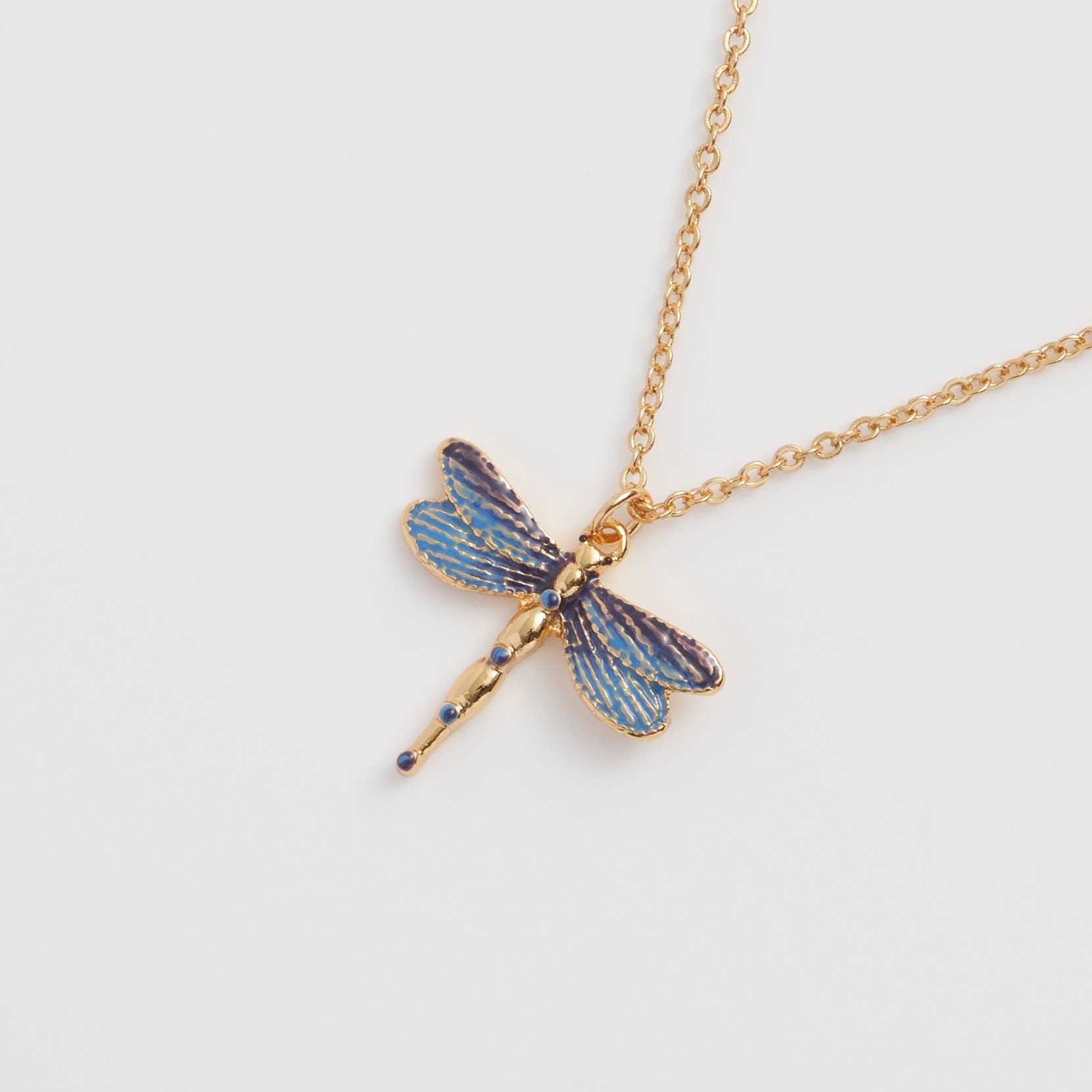 Dragonfly Pendant Necklace close up showing blue enamel wings on gold chain