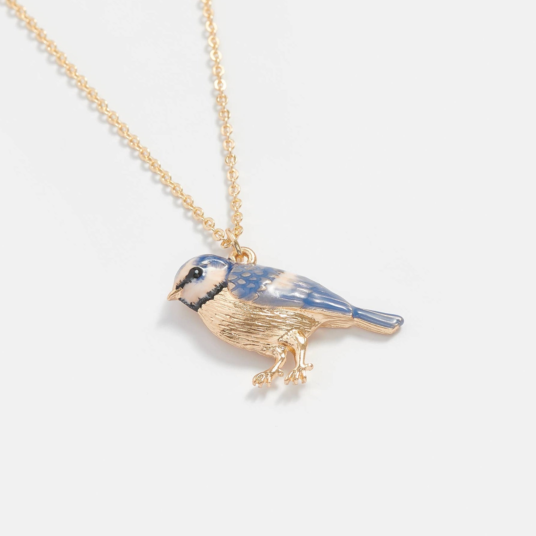 Enamel Blue Tit Short Necklace pendant close up against pale background