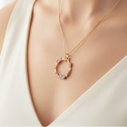 Hibiscus enamel necklace worn on model with white top