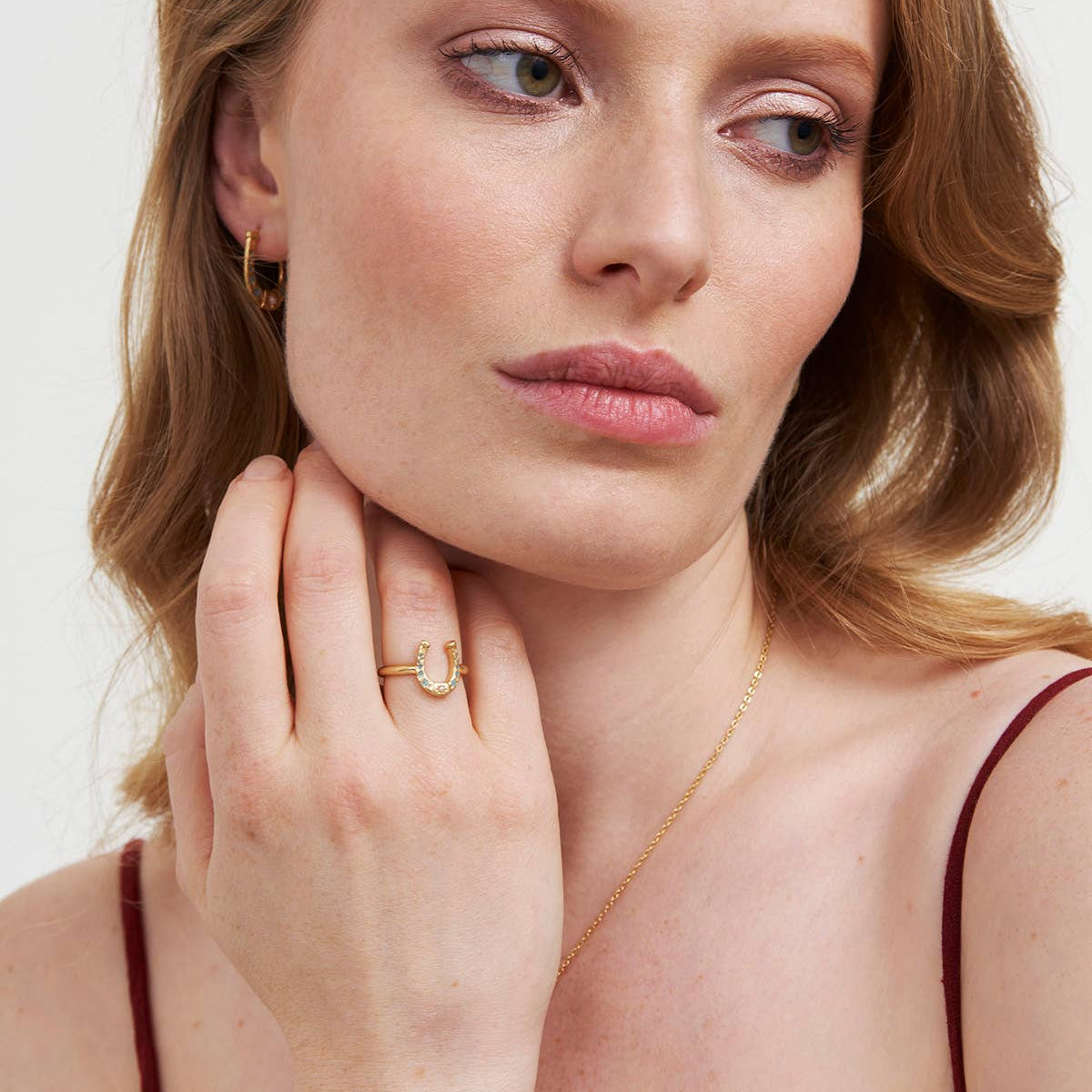 Horseshoe ring worn on model hand showing scale and styling