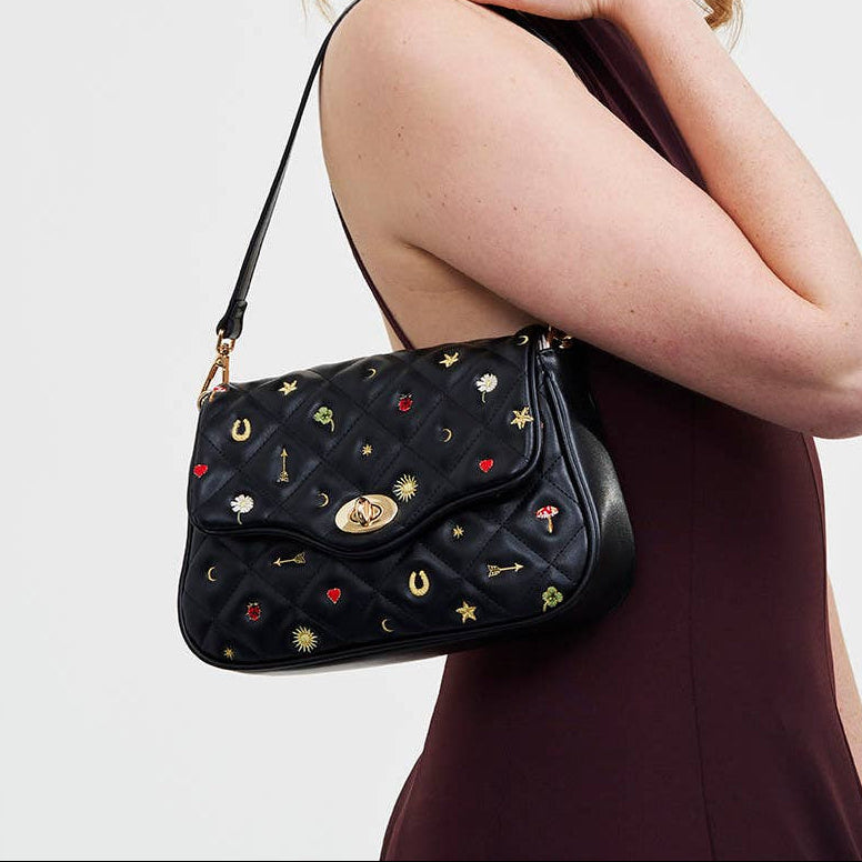 Black Quilted Motif Embroidered Crossbody angled view displaying turn-lock closure and quilted texture