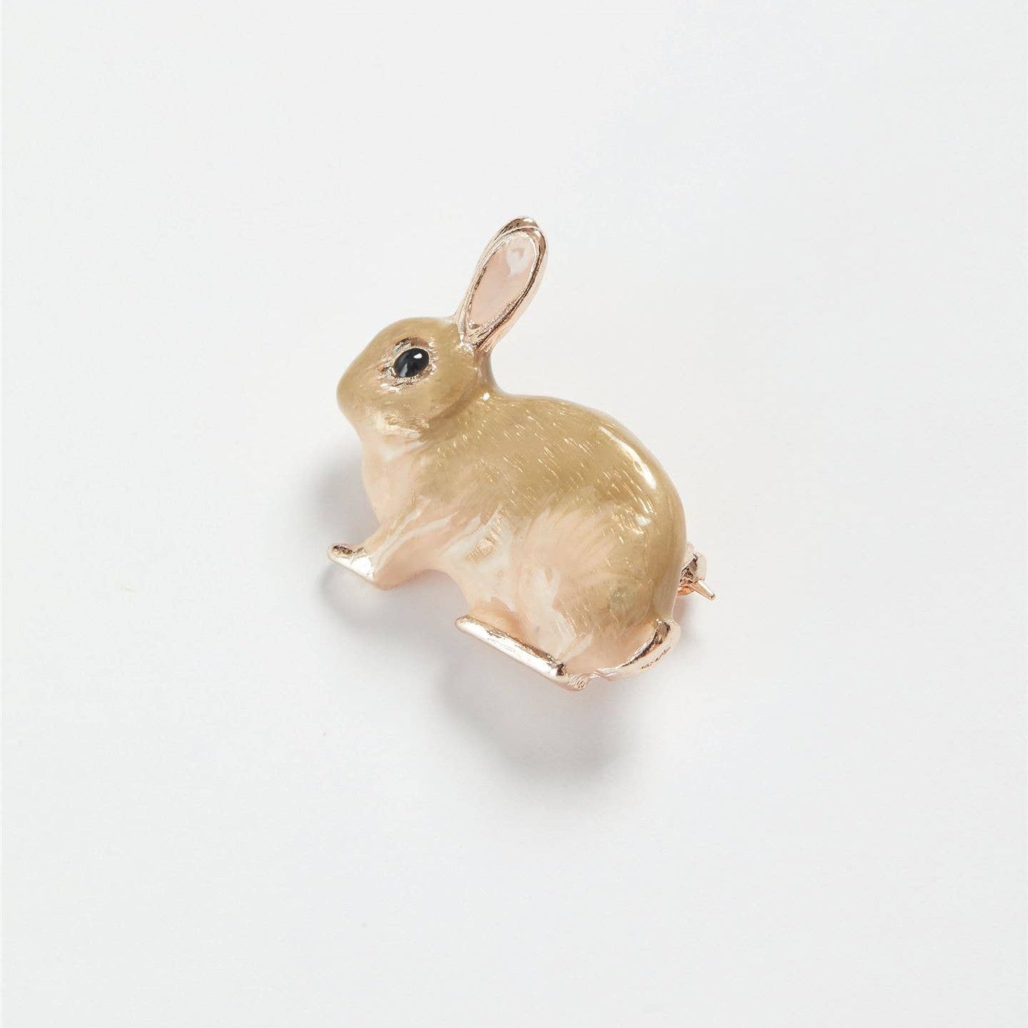 Enamel rabbit brooch angled view on white background