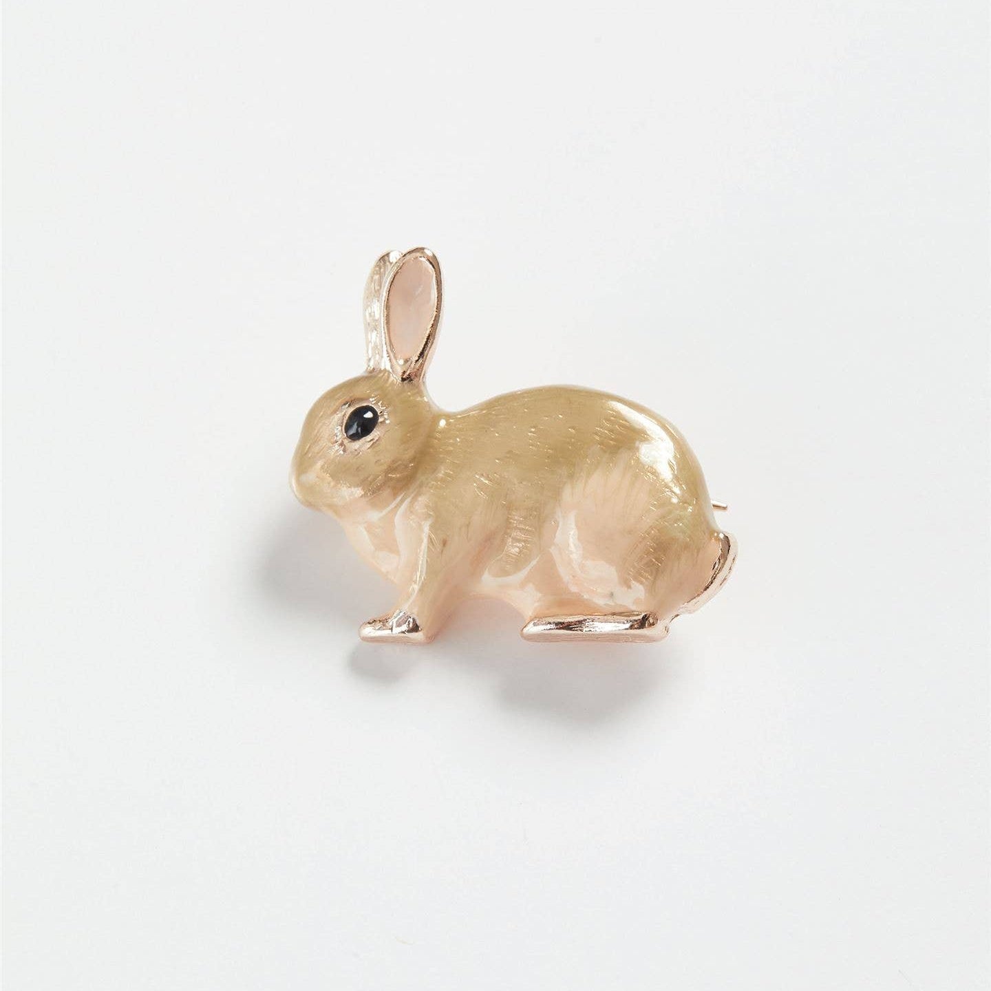 Enamel rabbit brooch side view on white background showing detail