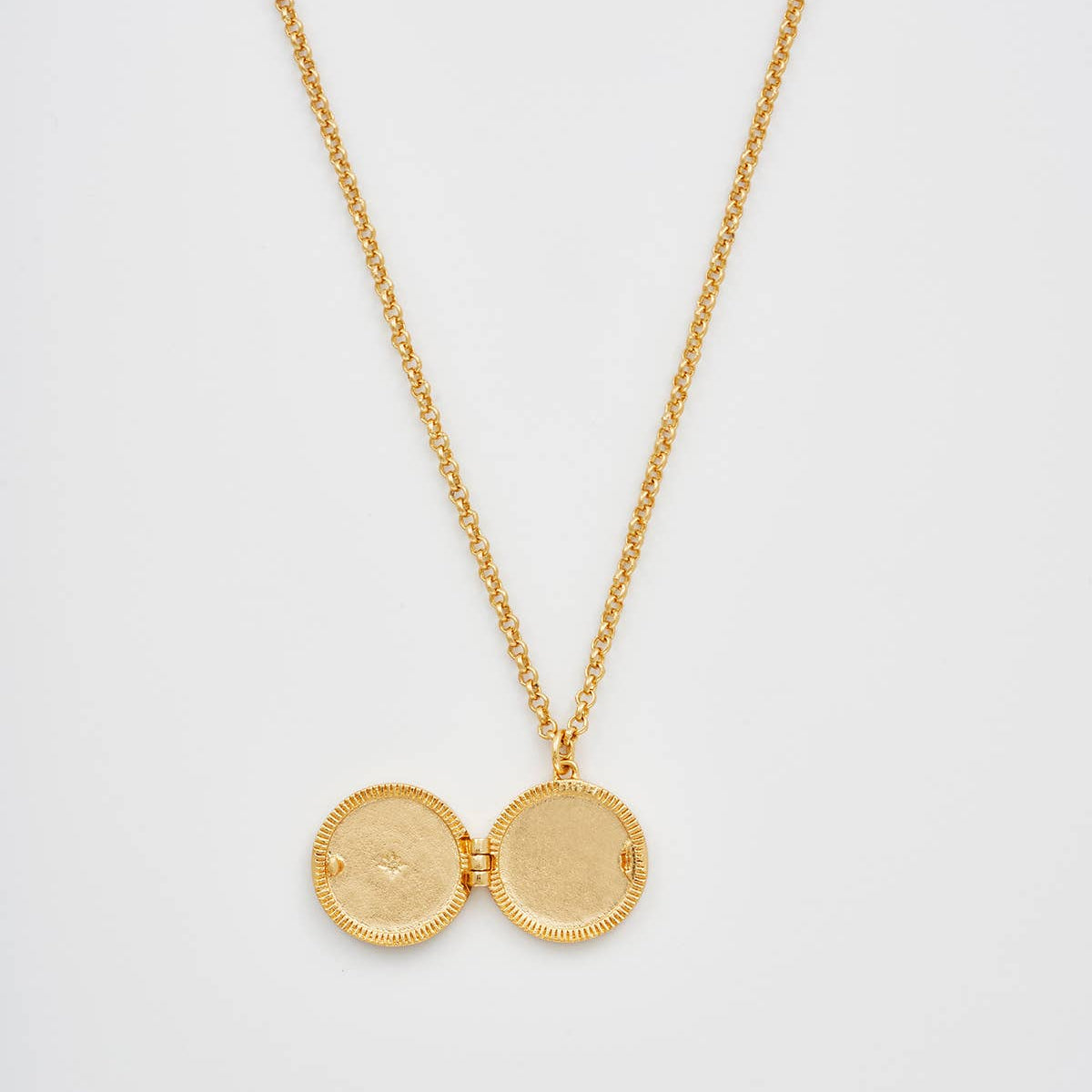 Sun locket open showing interior compartments on white background