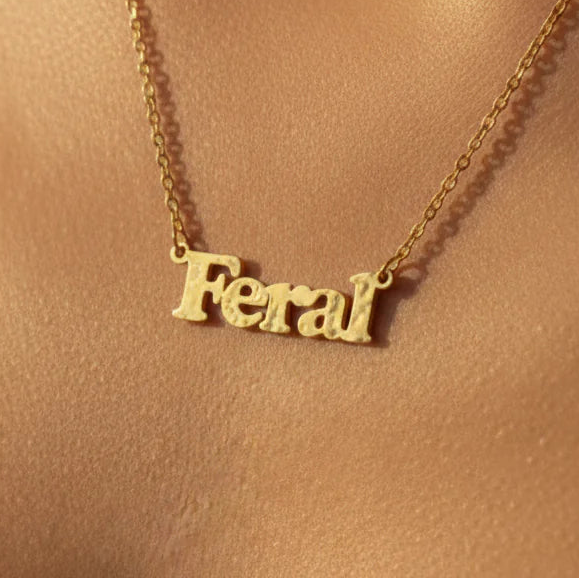 Gold feral necklace worn around neck on model