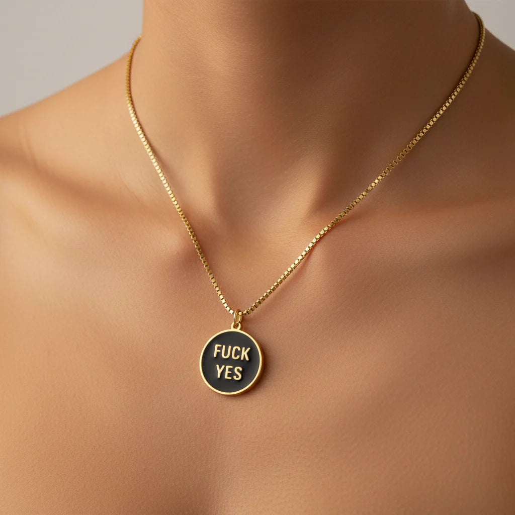 Gold fuck yes pendant necklace close-up detail shot