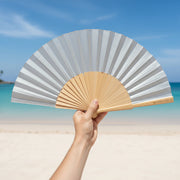 Silver shimmer fan held at beach location