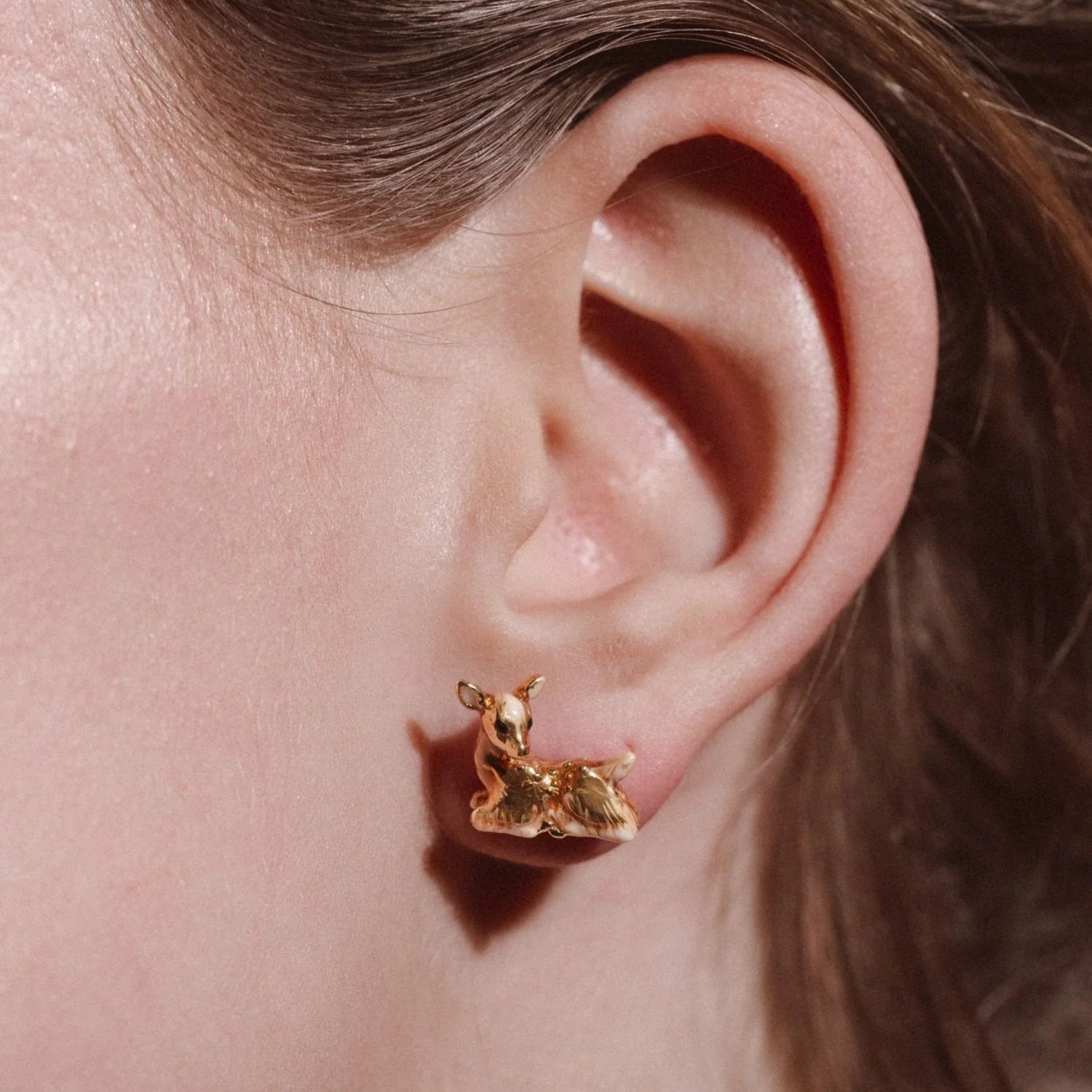 Close-up of Fawn Stud Earring worn on ear showing delicate enamel detailing and rhodium finish.