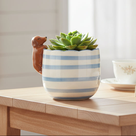 Cream ceramic planter with peeking dachshund dog design on white background