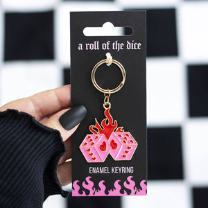 Flaming dice enamel keyring with pink dice and red flames on backing card