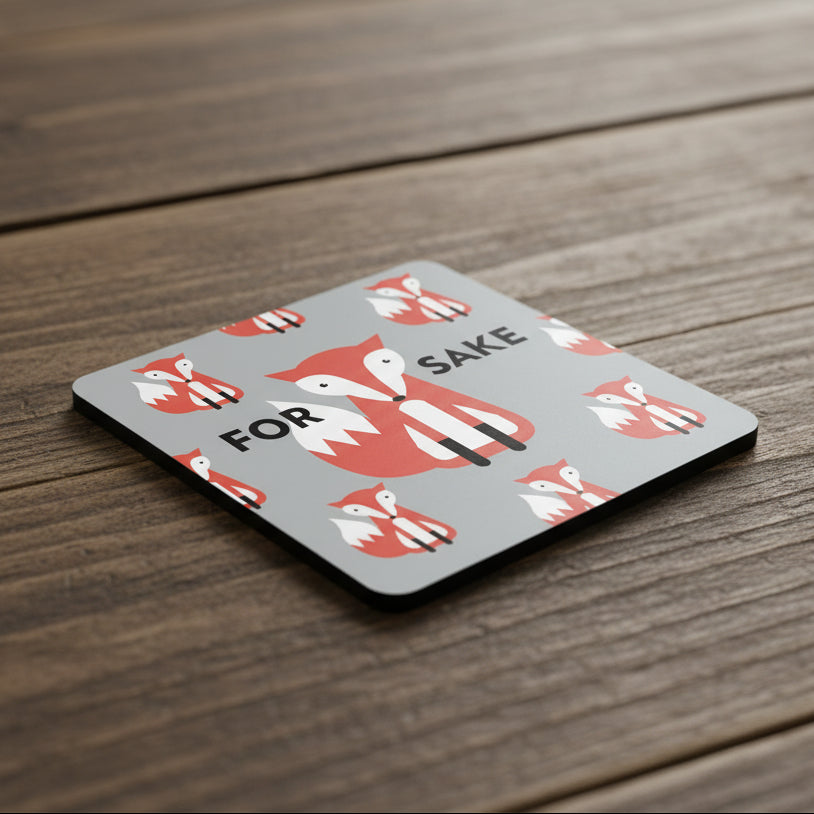 Grey square coaster with repeating red fox illustrations and the phrase “For Fox Sake” in bold text.
