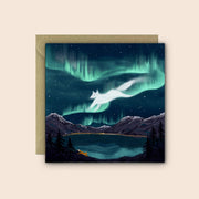 Fox Fire Folklore greetings card featuring a fox beneath the northern lights illustrated in deep blues and greens