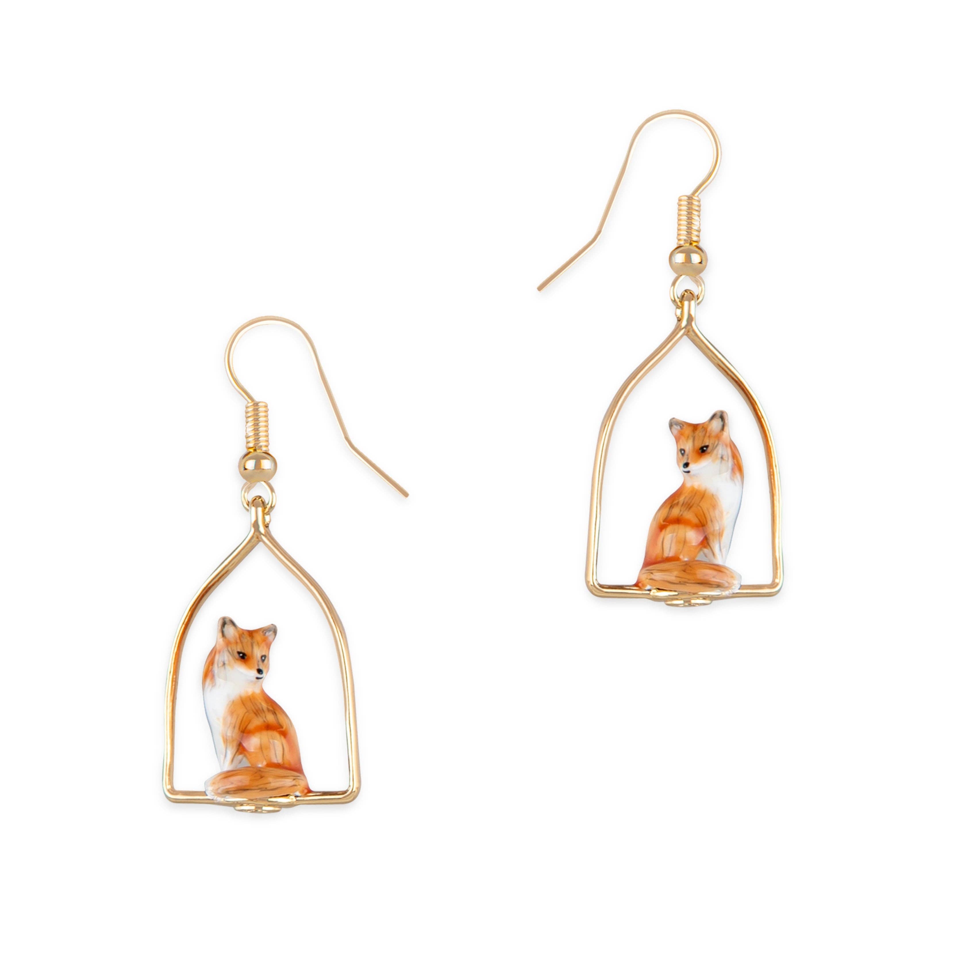 Fox Frame Earrings by Bill Skinner with hand-enamelled foxes framed in polished gold on white background.