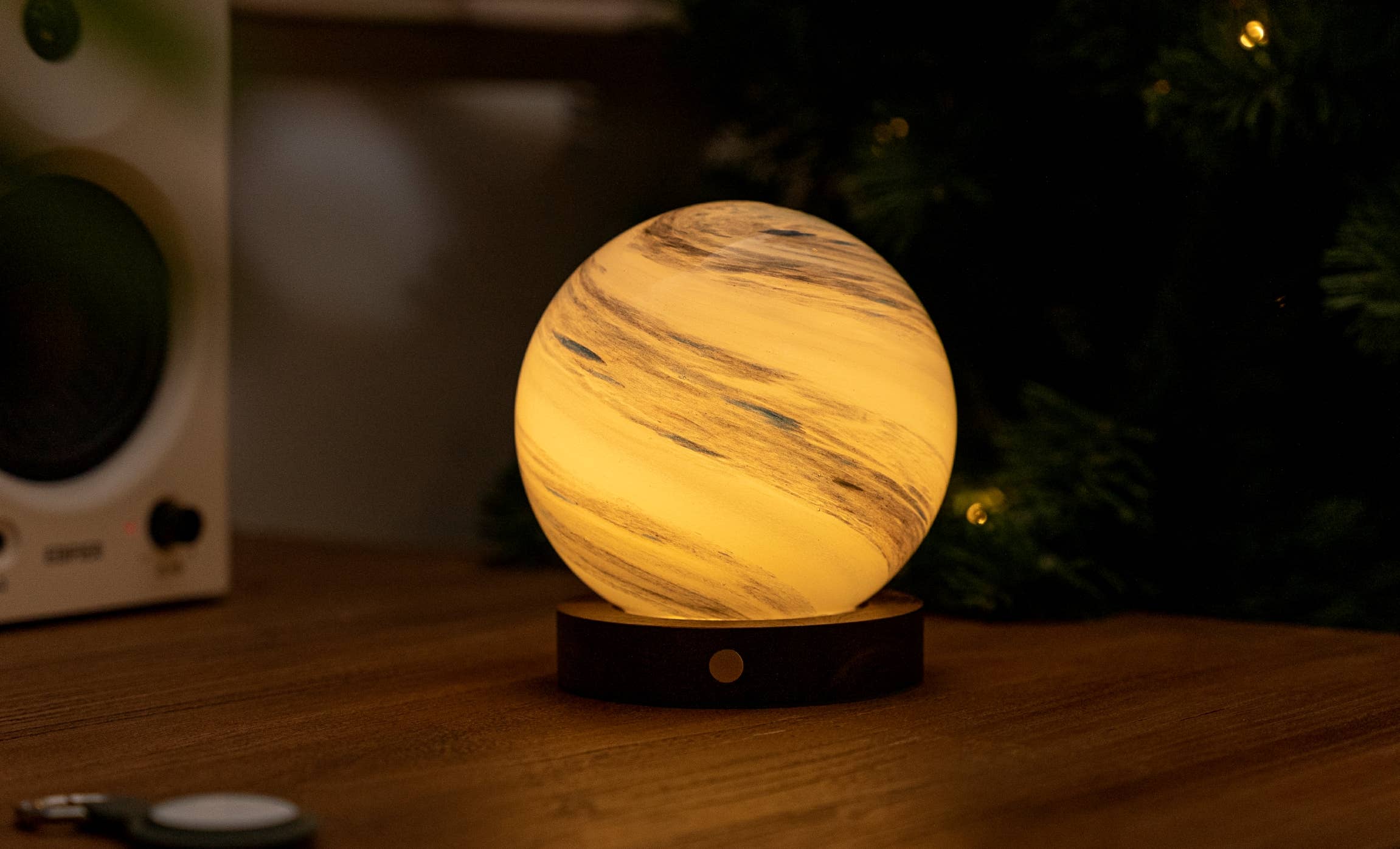 AstraGlass light glowing warm white with grey marbling by tree lights