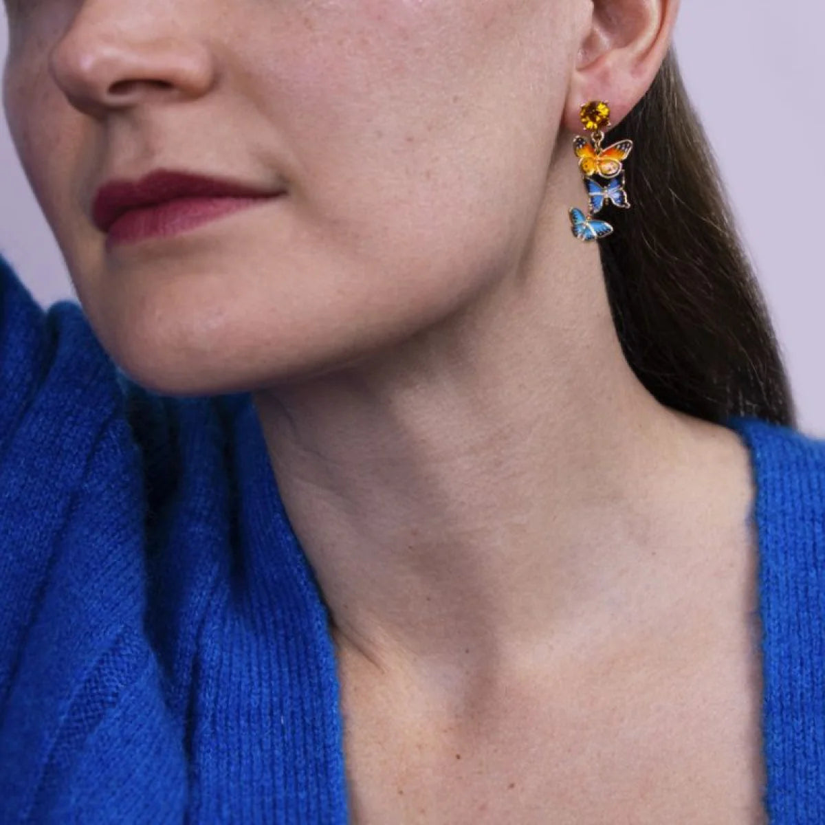 Close-up of Bill Skinner Butterfly Drop Earrings with crystal stud and gold-plated finish.