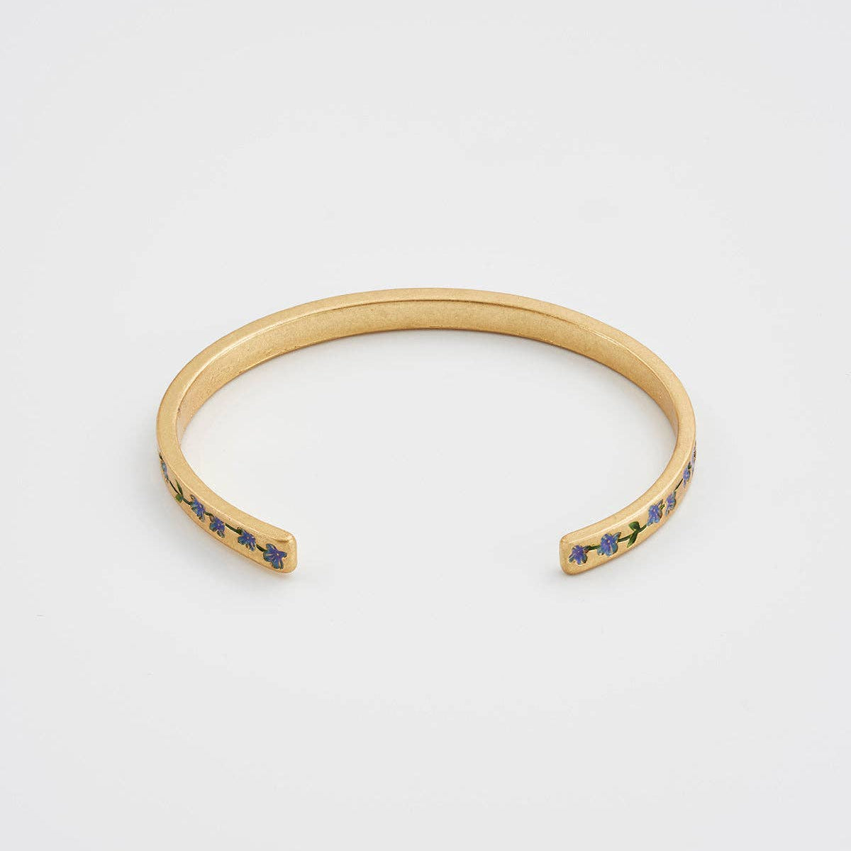 Side view of gold floral open-cuff bangle