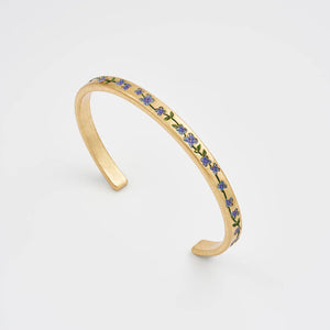 Gold forget me not bangle with blue floral detailing on white background