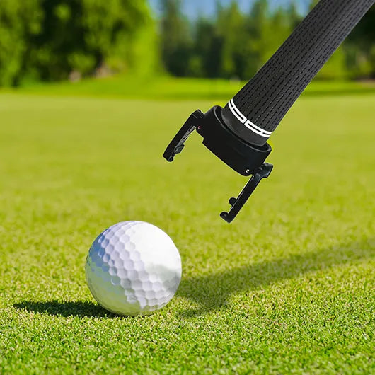 Golf ball pick up claw attached to putter lifting ball.