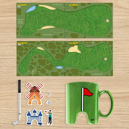 Golf mug and coasters kit laid out with obstacles, ball and pen