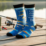 Blue men’s bamboo socks with fishing lure and fish illustrations and the phrase “Good things come to those who bait”.