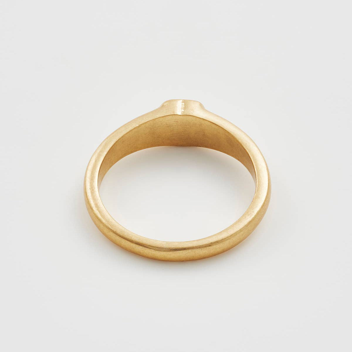 Worn gold plated ring band shown from the back.