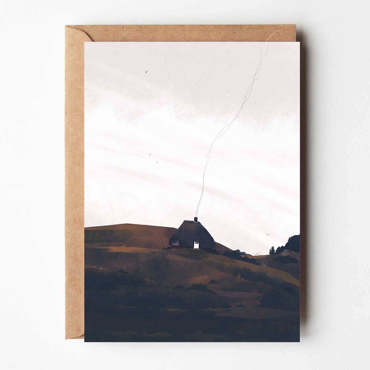 Home in the Borders greeting card featuring illustrated Danish cottage on rolling hills with kraft envelope.