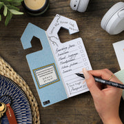 Leave The House Lists notepad open showing checklist on wooden desk