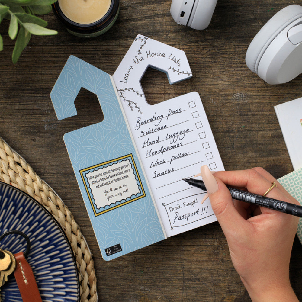 Leave The House Lists notepad open showing checklist on wooden desk