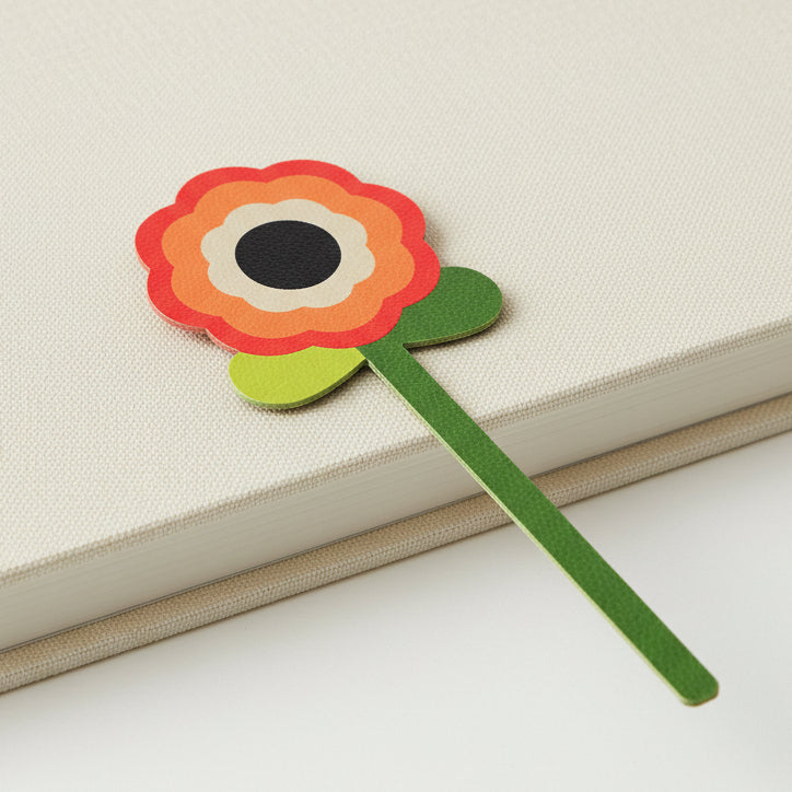 Retro flower bookmark with concentric circles on closed cream book