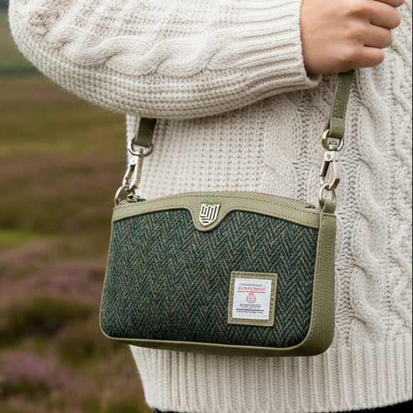 Ailsa dark green herringbone Harris Tweed purse worn crossbody on moorland