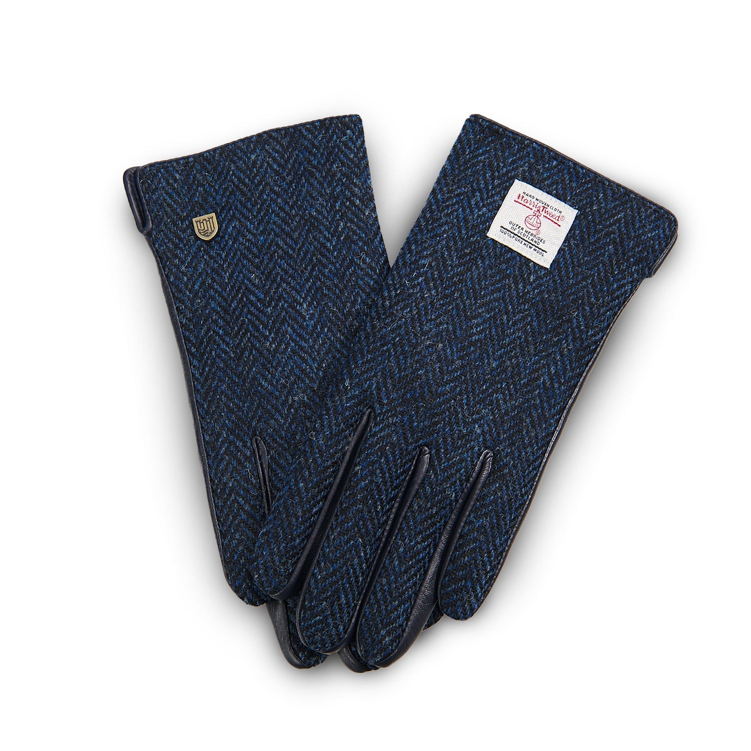 Navy herringbone Harris Tweed gloves worn holding enamel mug on Scottish moorland