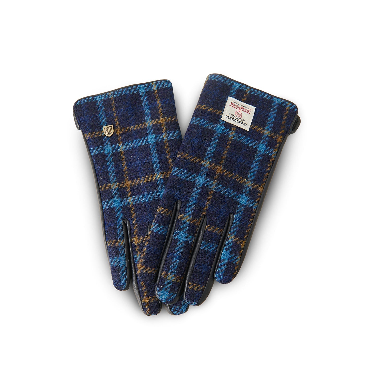 Navy tartan Harris Tweed glove gripping walking stick on Scottish hillside
