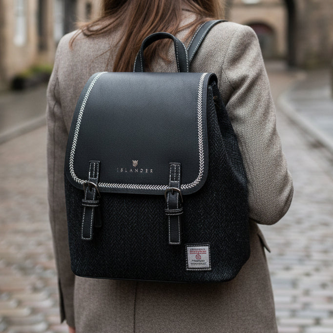 Harris Tweed black herringbone backpack worn on cobblestone street