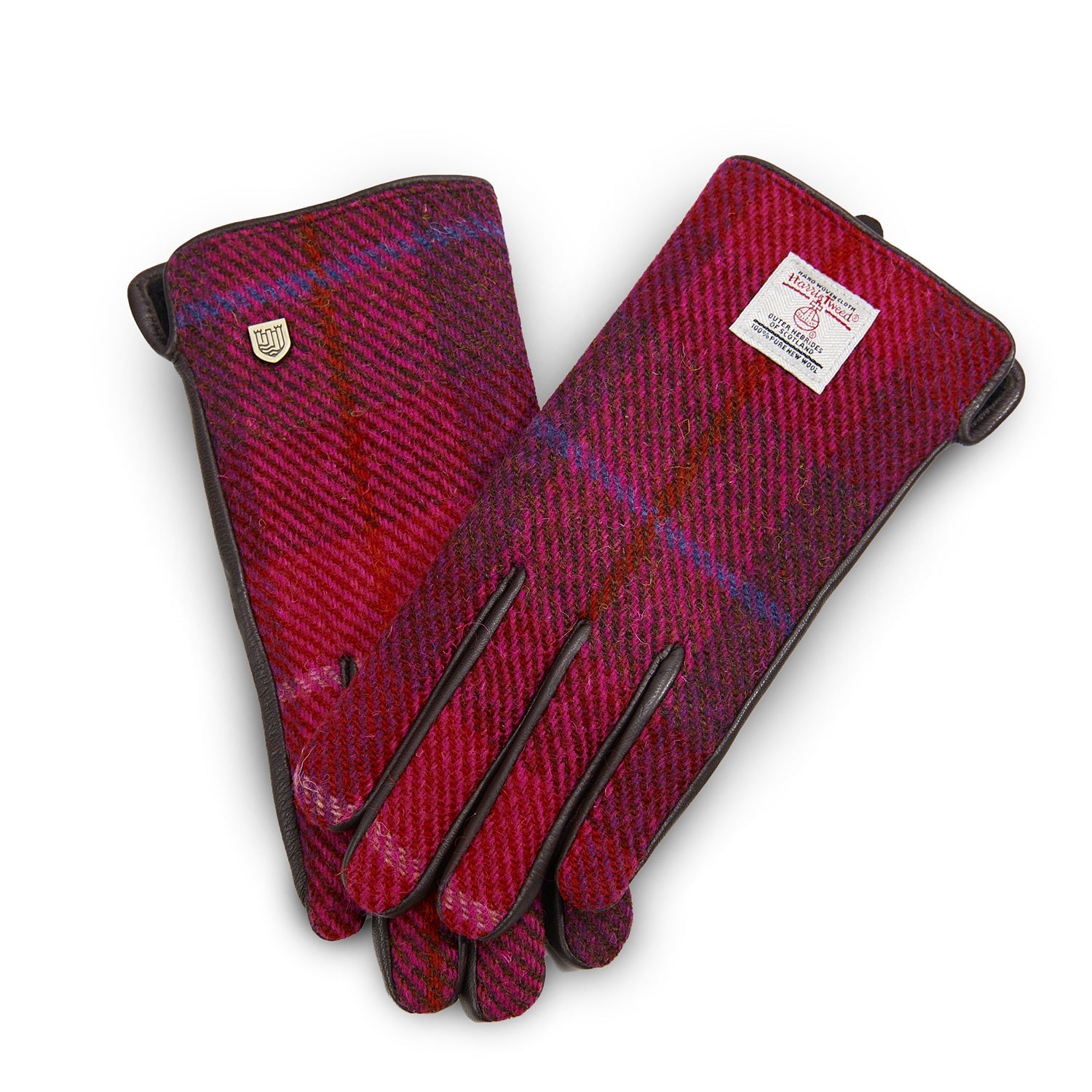 Fuchsia tartan Harris Tweed gloves worn holding steaming cup in cosy indoor setting
