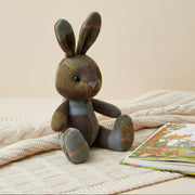 Lambswool bunny in chestnut and blue tartan on cream knitted blanket.