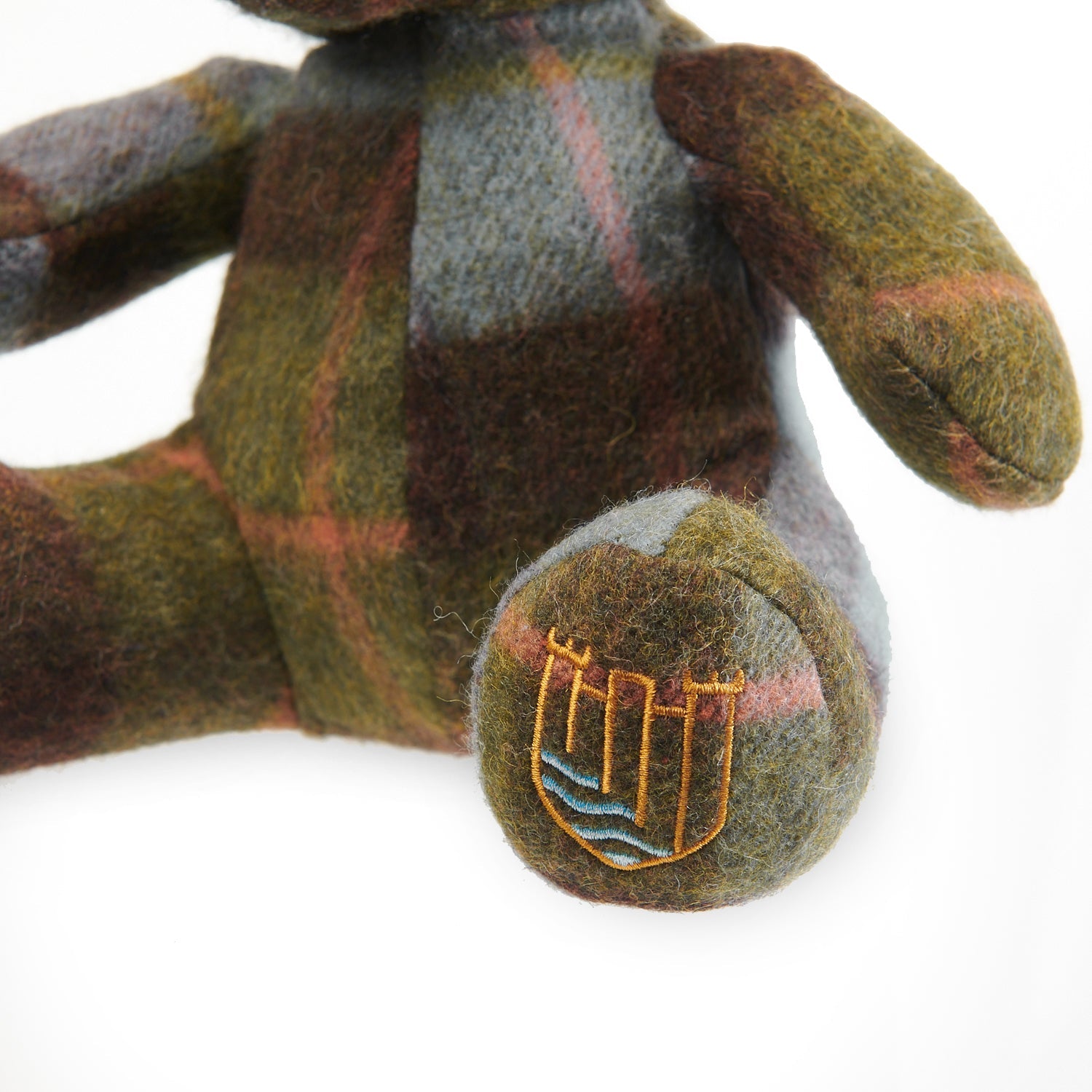 Close-up of embroidered Islander crest on lambswool teddy foot.