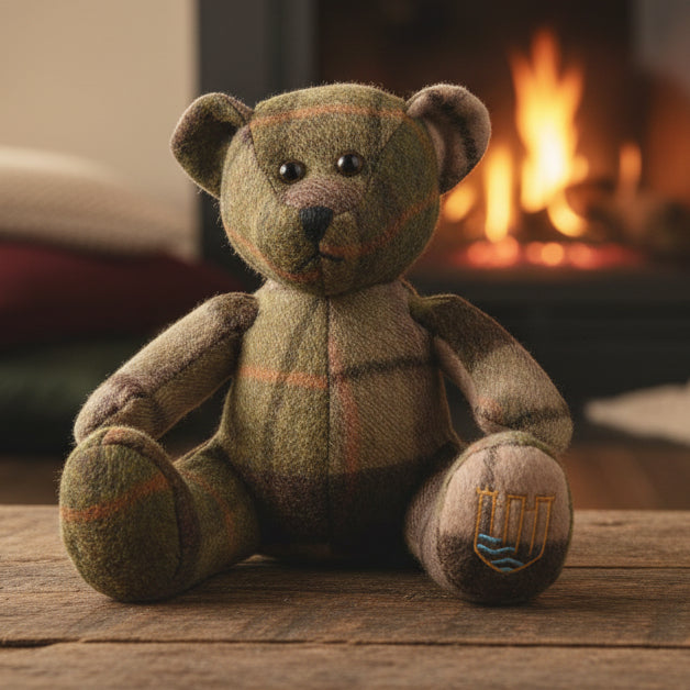 Lambswool teddy in chestnut tartan by fireplace lifestyle setting.