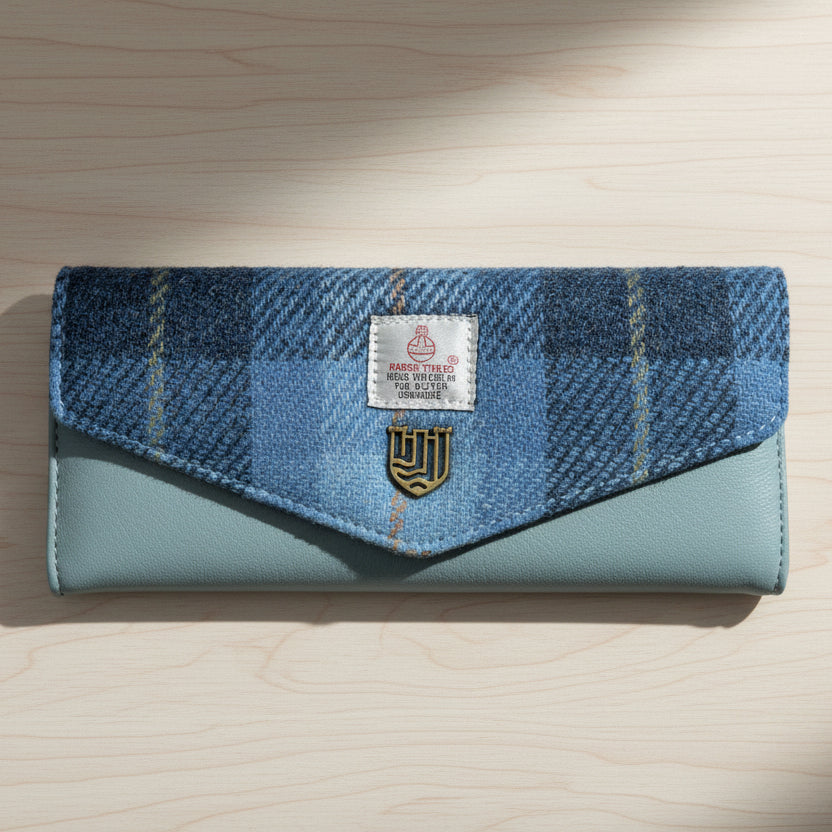 Blue tartan Harris Tweed clasp purse with pale blue leather on light wood